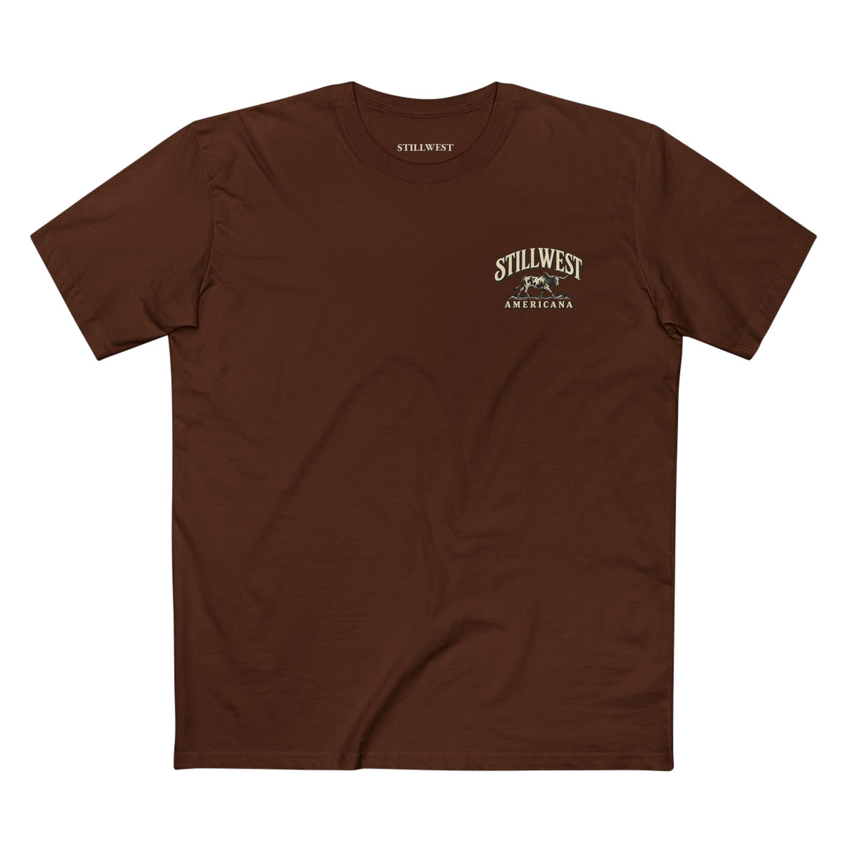 A brown short-sleeve crewneck t-shirt with a small vintage-style 'Still West Americana' graphic printed on the left chest, displayed flat against a solid white background.