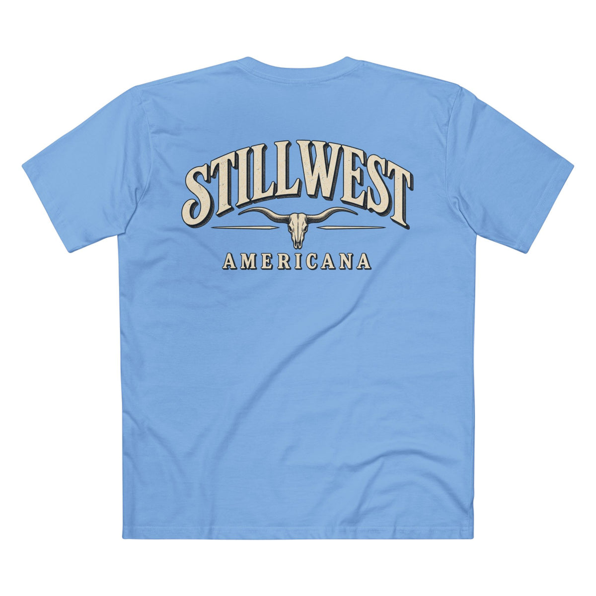 A light blue short-sleeve t-shirt shown from the back, featuring a large graphic print with the words 'STILLWEST AMERICANA' and a longhorn skull design in beige and dark brown tones.