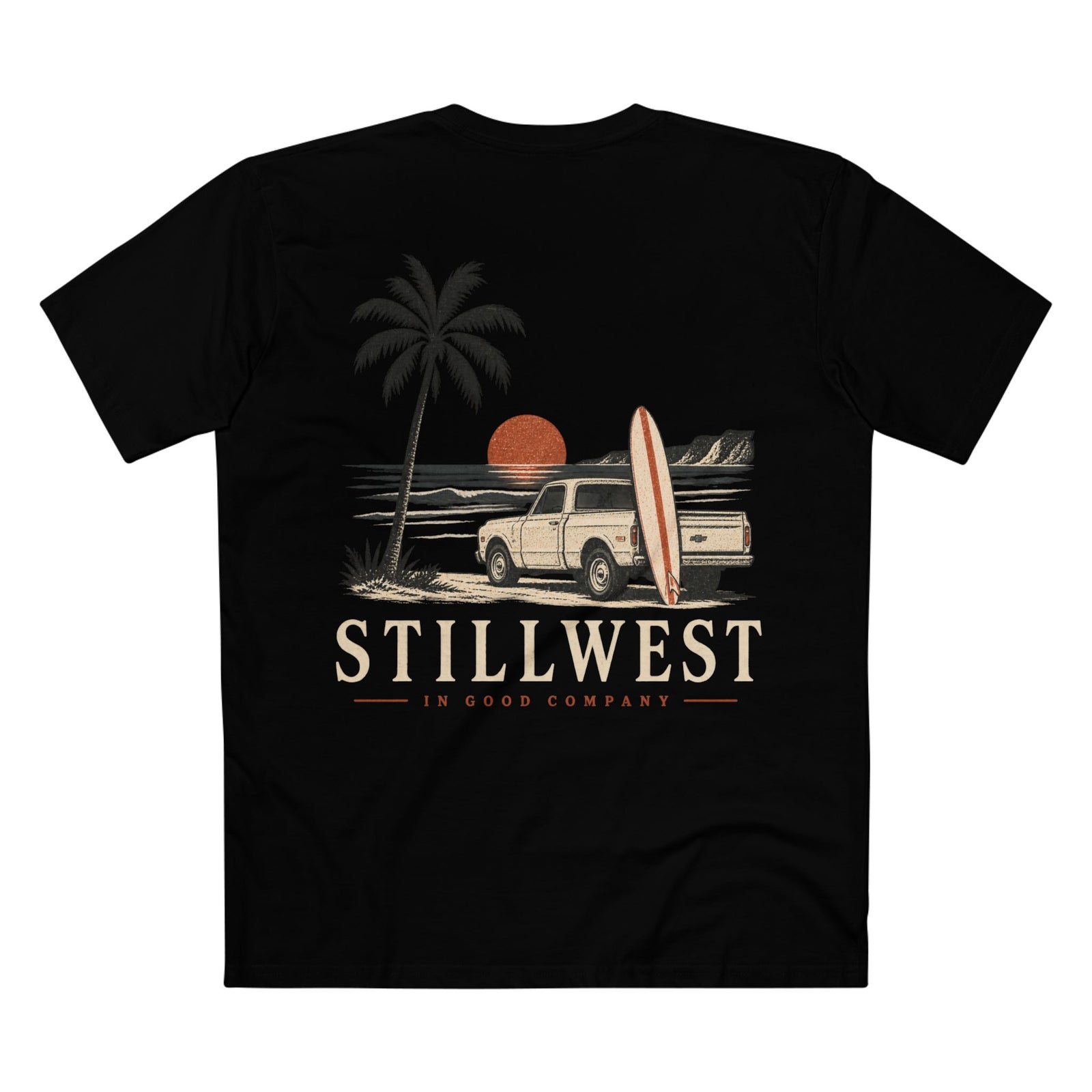 A black short-sleeve t-shirt with a retro-style beach graphic on the front. The graphic features a palm tree, a white pickup truck, a surfboard, and an orange sun over the text 'STILLWEST IN GOOD COMPANY'.