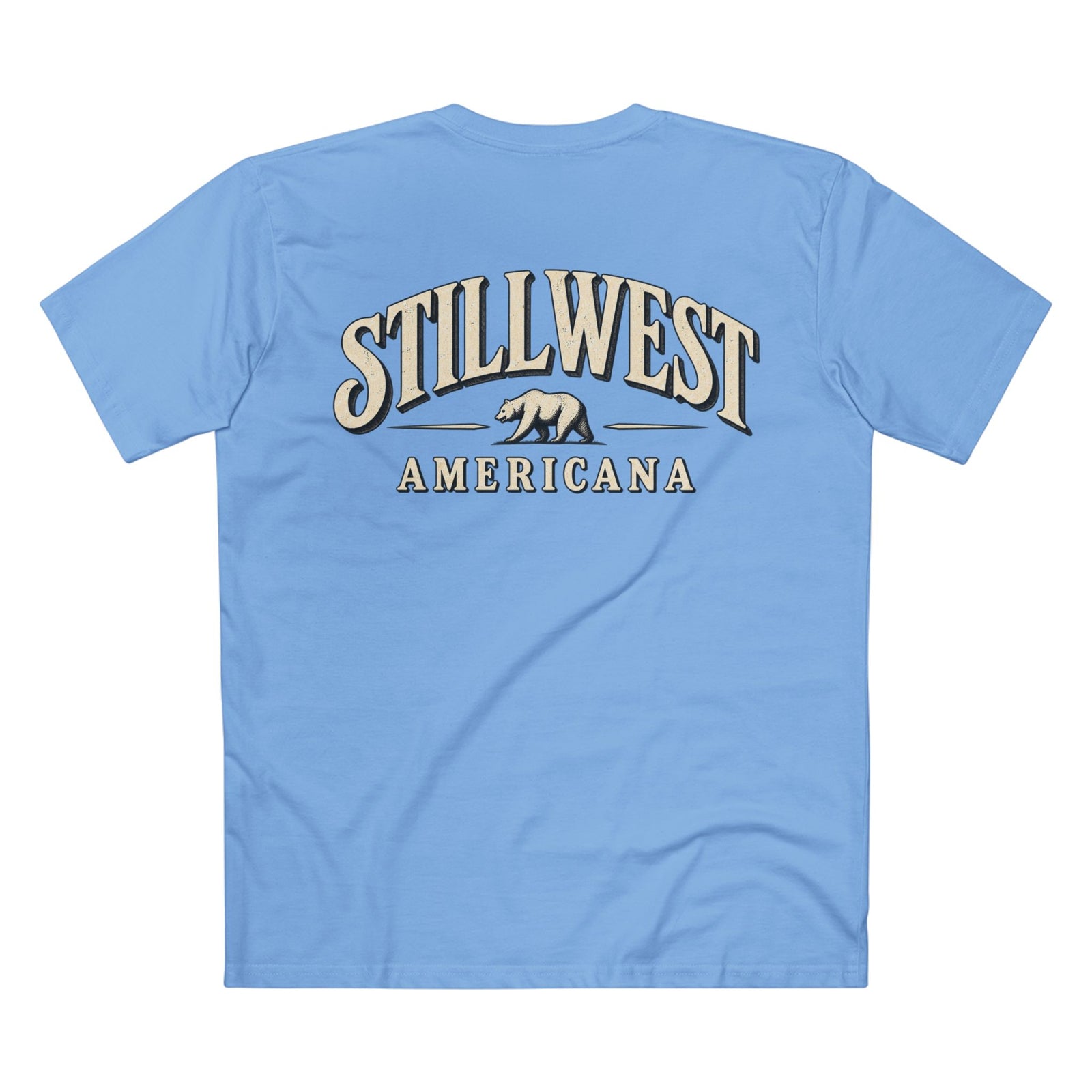 A light blue short-sleeve t-shirt shown from the back, featuring a large graphic print with the words 'STILLWEST AMERICANA' and a bear logo in beige and dark blue.