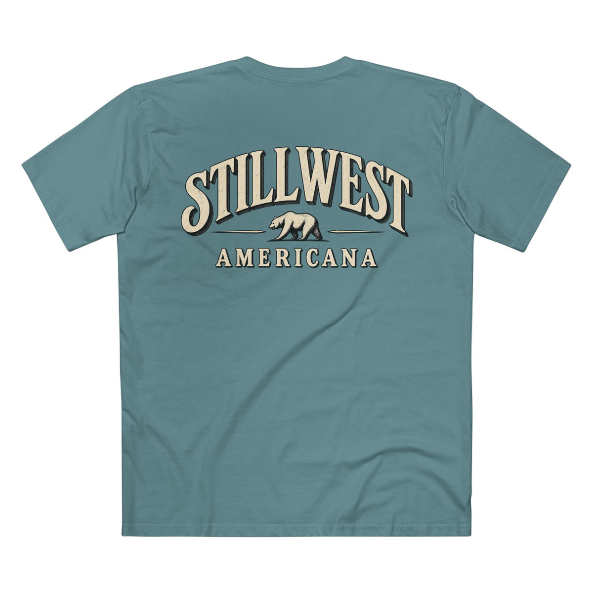 A teal blue short-sleeve t-shirt shown from the back, featuring a vintage-style graphic with the words 'STILLWEST AMERICANA' and a grizzly bear in beige and cream tones.