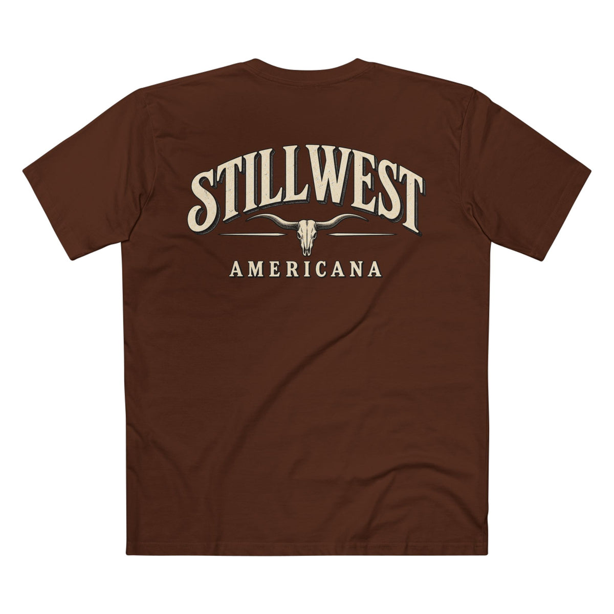 A brown short-sleeve t-shirt shown from the back, featuring a cream-colored graphic print that reads 'STILLWEST AMERICANA' with a longhorn skull design in the center.