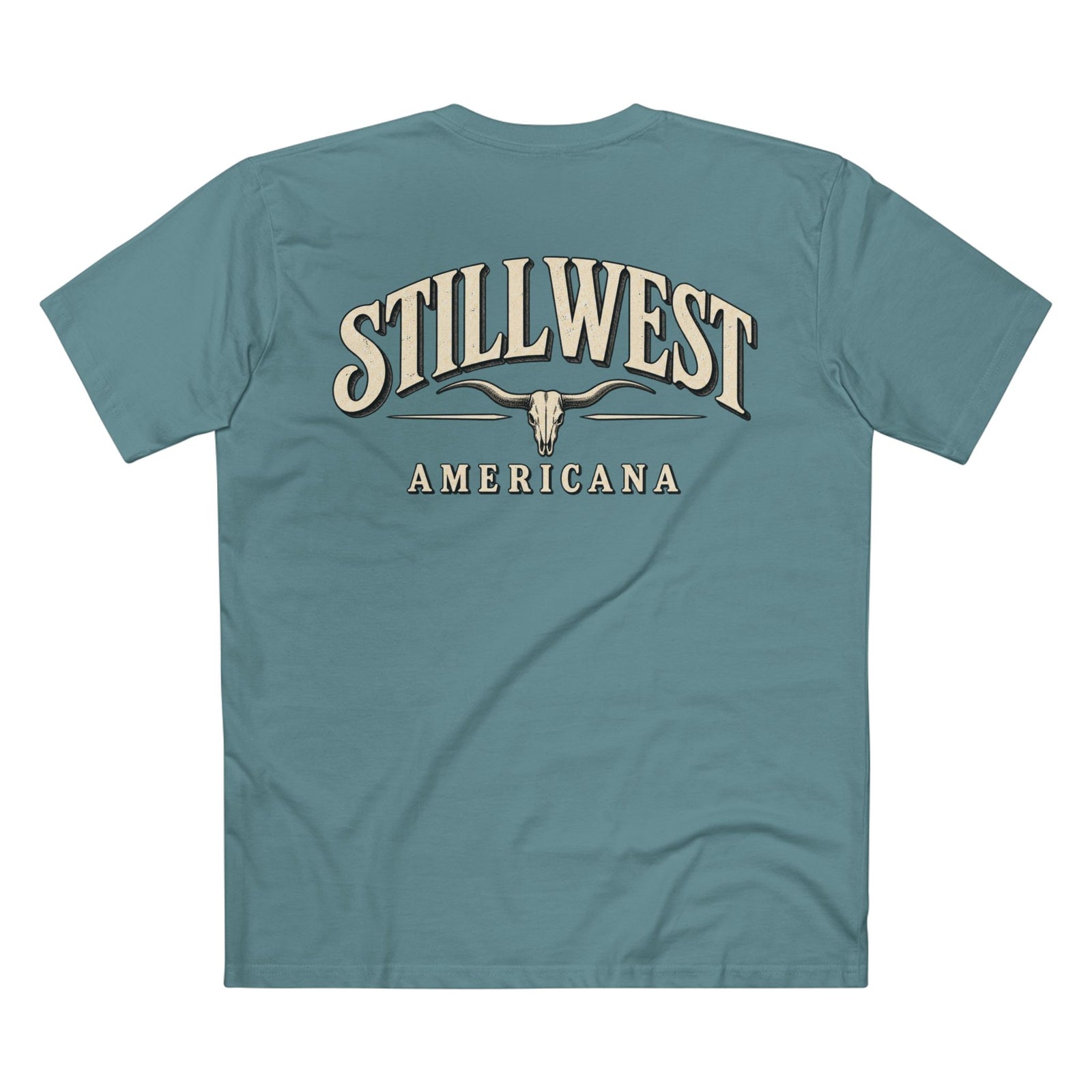 A teal blue short-sleeve t-shirt shown from the back, featuring a large graphic print with the words 'STILLWEST AMERICANA' in a beige western-style font and a longhorn skull illustration.